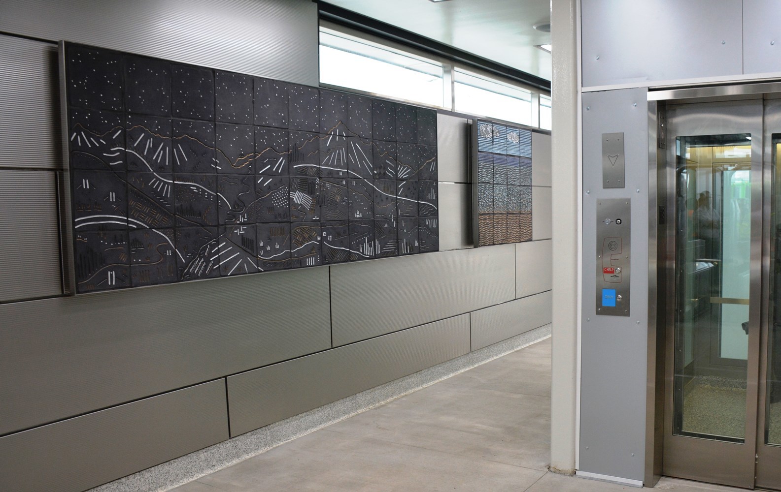 Riders passing through the Ogden entrance of IMD are welcome by two ceramic tile murals known as Vista and Beach, respectively.