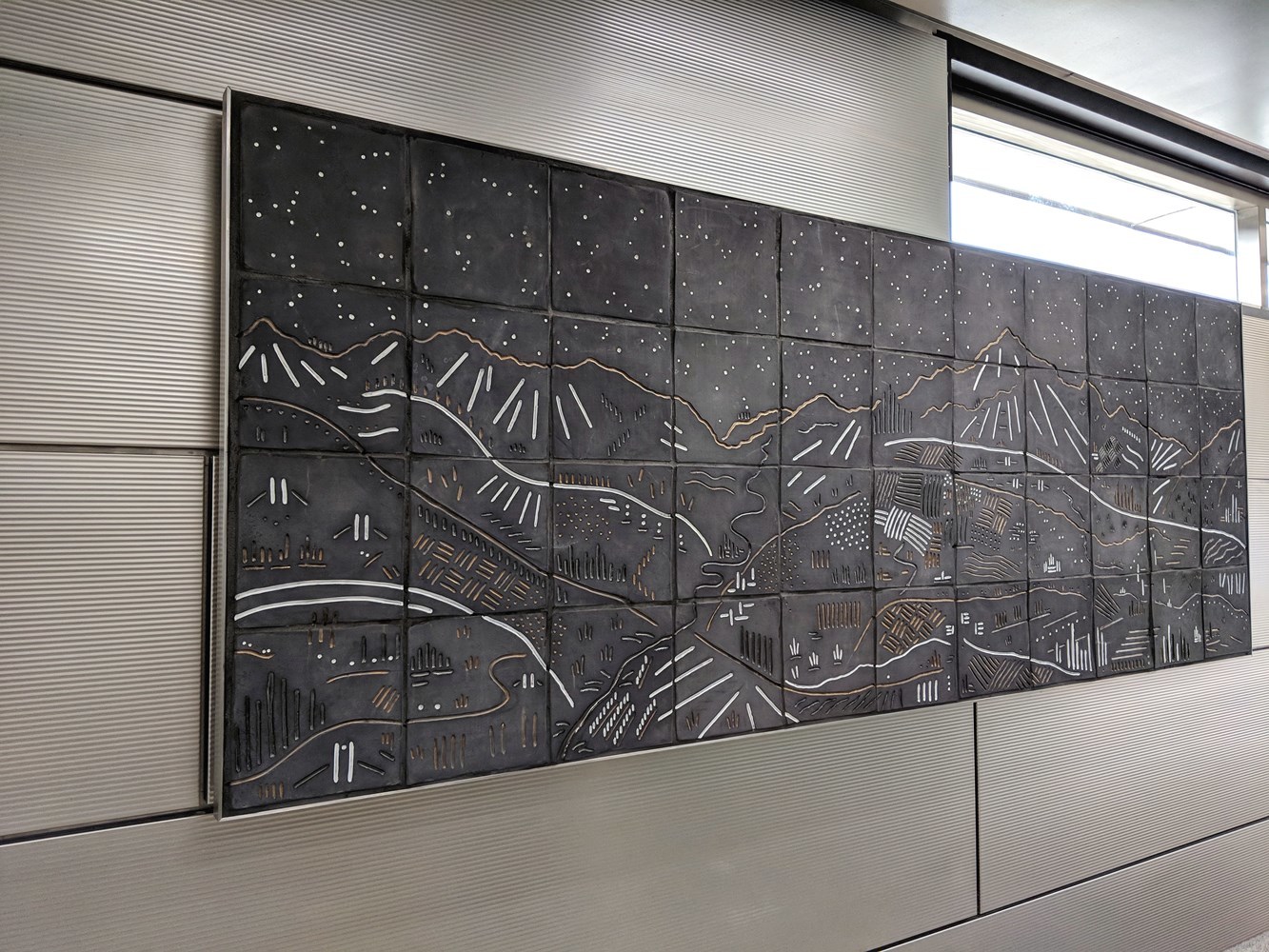 IMD station features a new series of artwork known as "Vacation" by Chicago artists Jason Messinger. Shown is the "Vista" mural in the Ogden Avenue entrance.