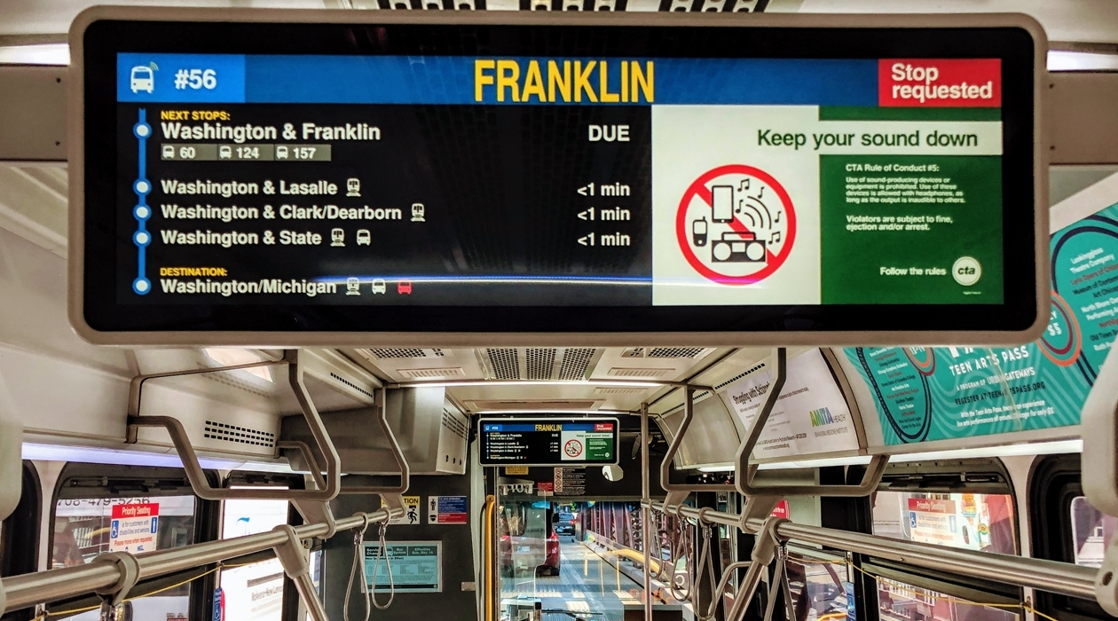 A screen shows information about upcoming stops on a bus