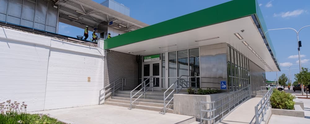 Station with stairs, ramps and a canopy painted green.