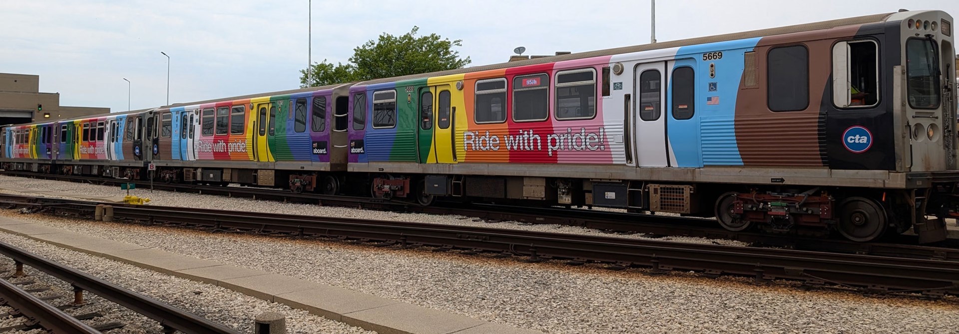 The Pride Train parked at a train yard.