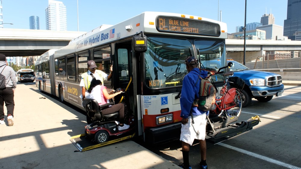 A wheelchair user getting on a bus.