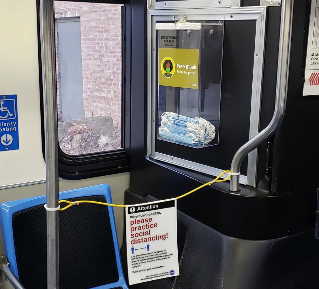 New disposable face mask dispenser installed on a CTA bus