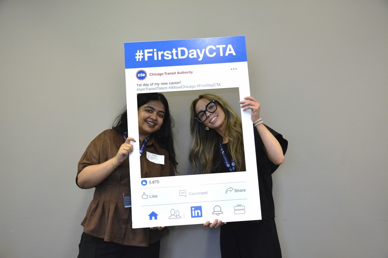 Interns posing inside a prop frame that says "first day of my new career"