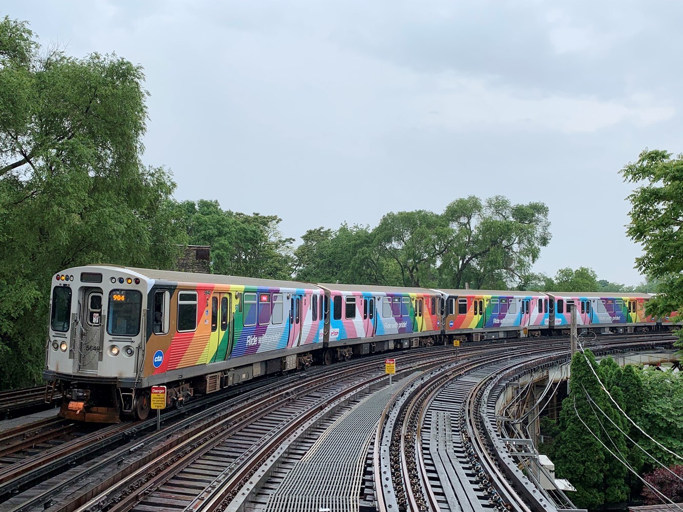 The 2022 CTA Pride Train, featuring a new wrap on all eight railcars, as it approaches the Sheridan Red Line station
