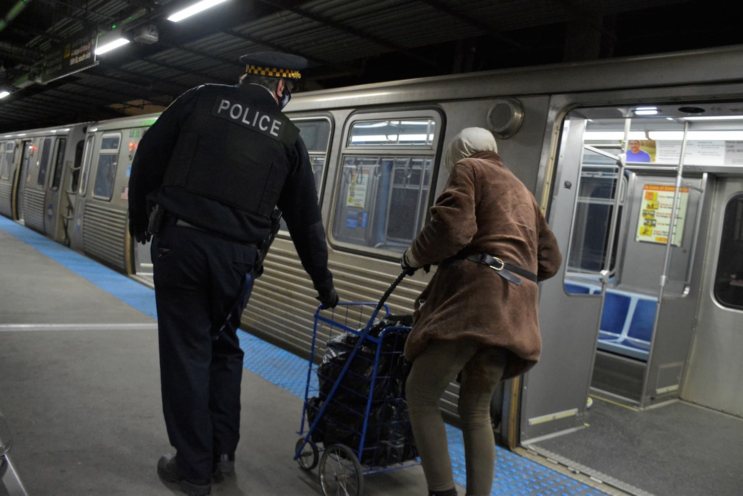 A police officer helping an unhoused individual