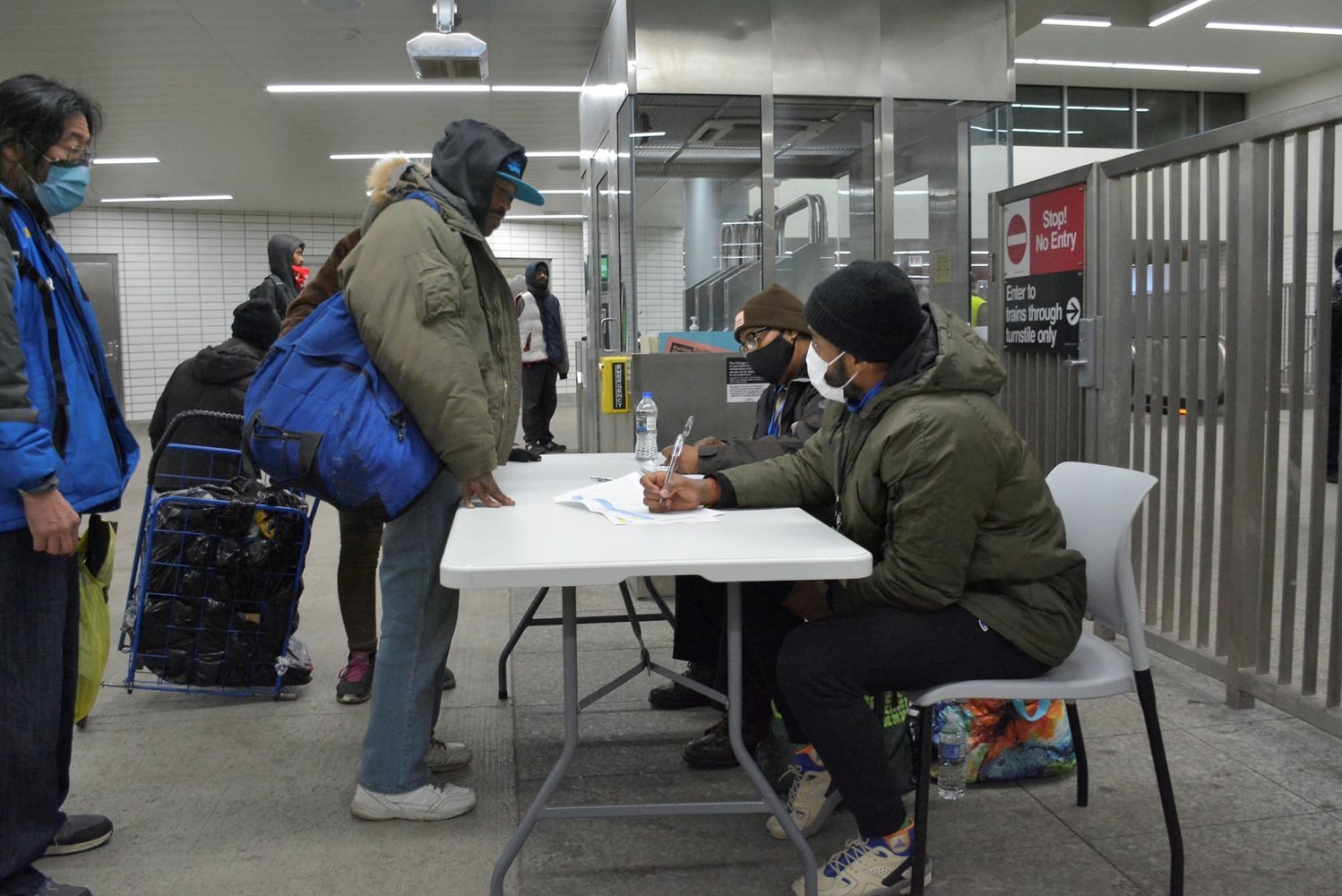 Employees at a table helping riders