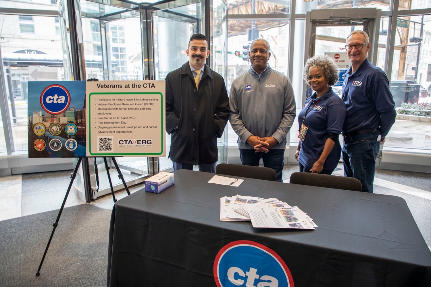 CTA employees behind a table sharing information about the CTA Veteran Employee Resource Group