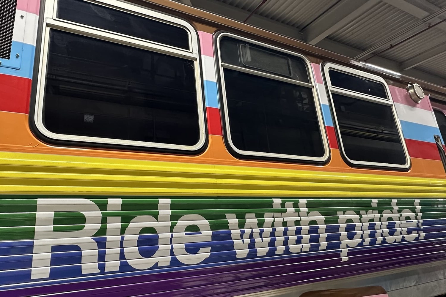 The words "ride with pride" printed on the pride train