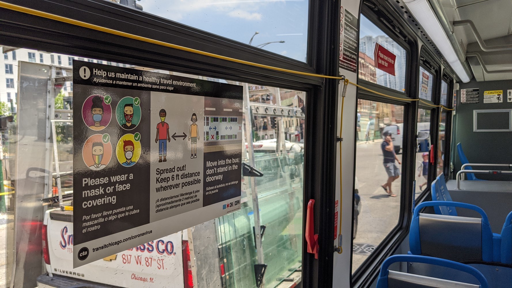 Signage on a bus encouraging social distancing, wearing of mask, etc.