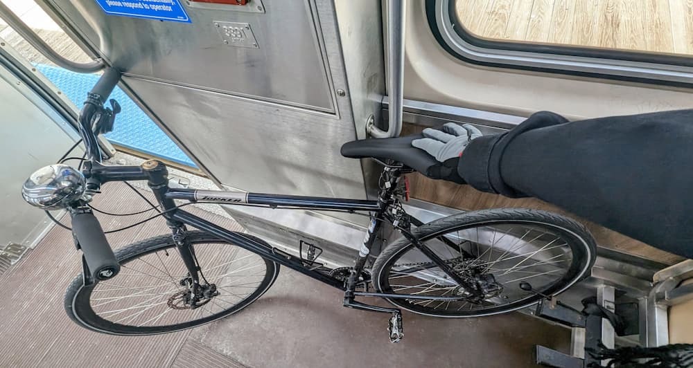 Bike in wheelchair area of the railcar with the seats flipped up