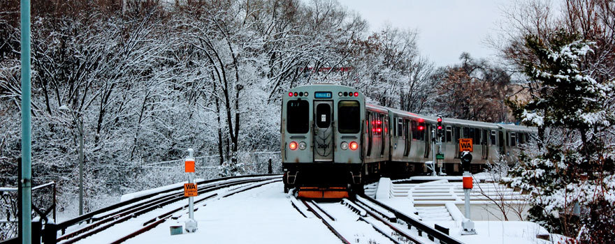 A Blue Line train leaving Forest Park in snow