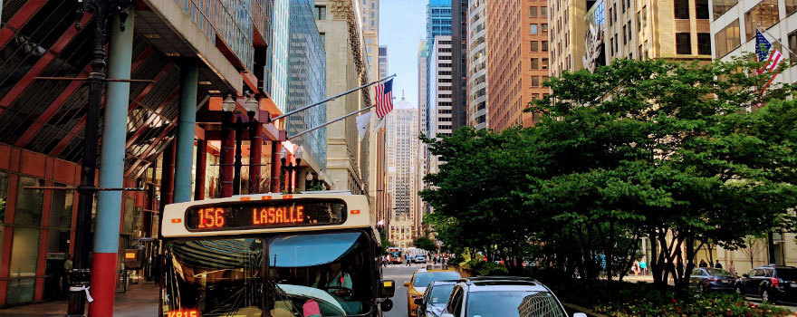 A bus on LaSalle street with the Chicago Board of Trade in the background