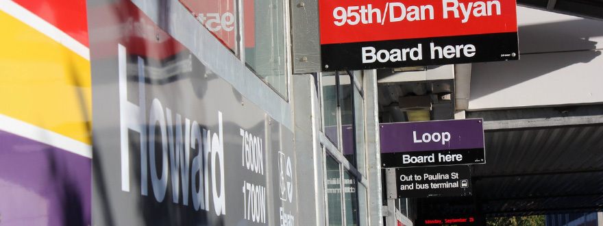 Signs at the Howard station saying Red Line 95th/Dan Ryan board here, Purple Line Loop board here