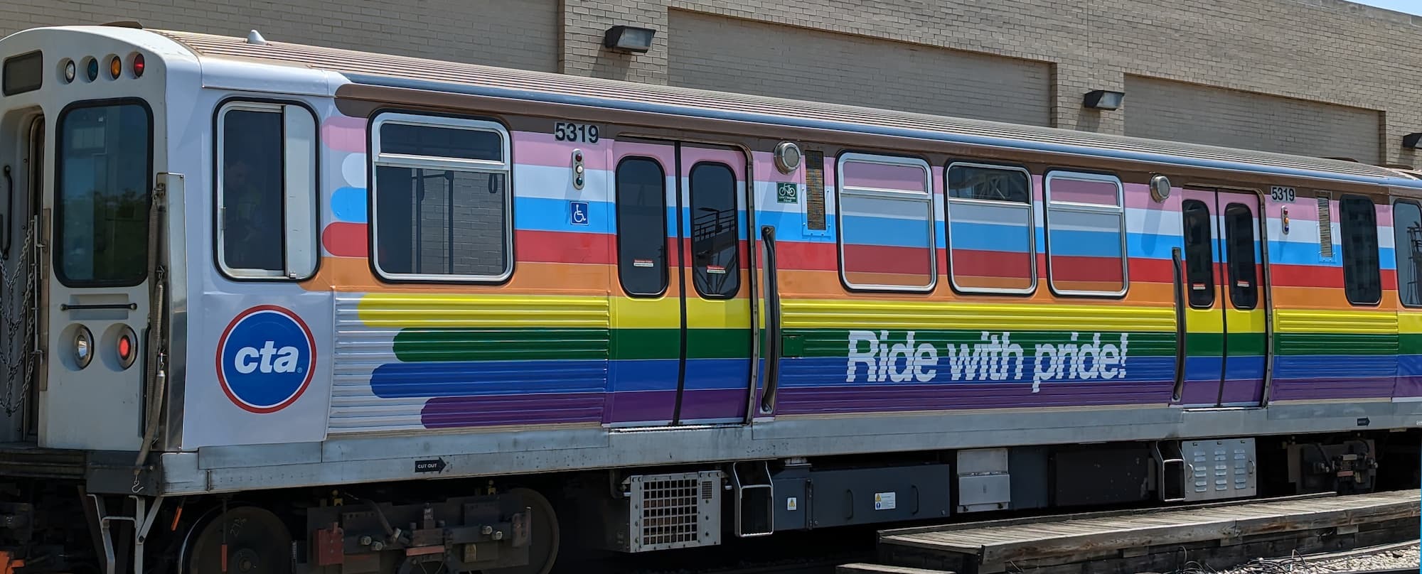 A train decorated with pride flag colors