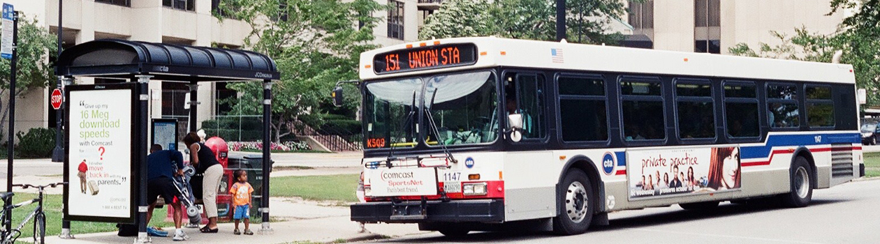 Parents with a folded stroller boarding a bus with an excited kid